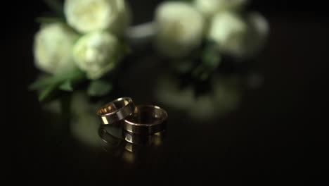 on the table wedding bouquet and rings