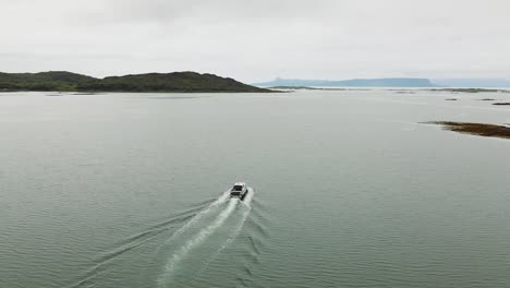 aerial shot of boat leaving arisaig harbour on west coast of scotland