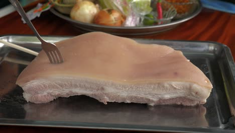 boiled pork belly meat being prepared in thailand cuisine style