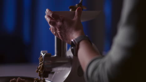 preparing minced meat in a mincer