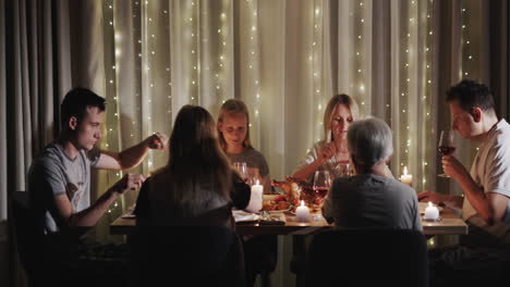 a large family is having dinner at the festive table