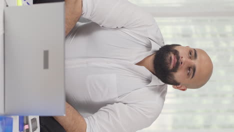 Vertical-video-of-Home-office-worker-man-depressed-and-unhappy.