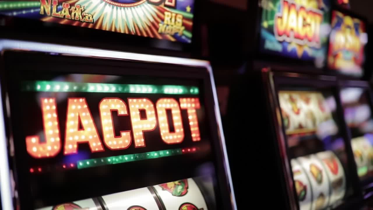 A Glimpse of Excitement: Capturing the Thrill of Winning 'JACKPOT' on Slot Machines in a Vibrant Casino Environment | Slots and Their Multicolored Lights