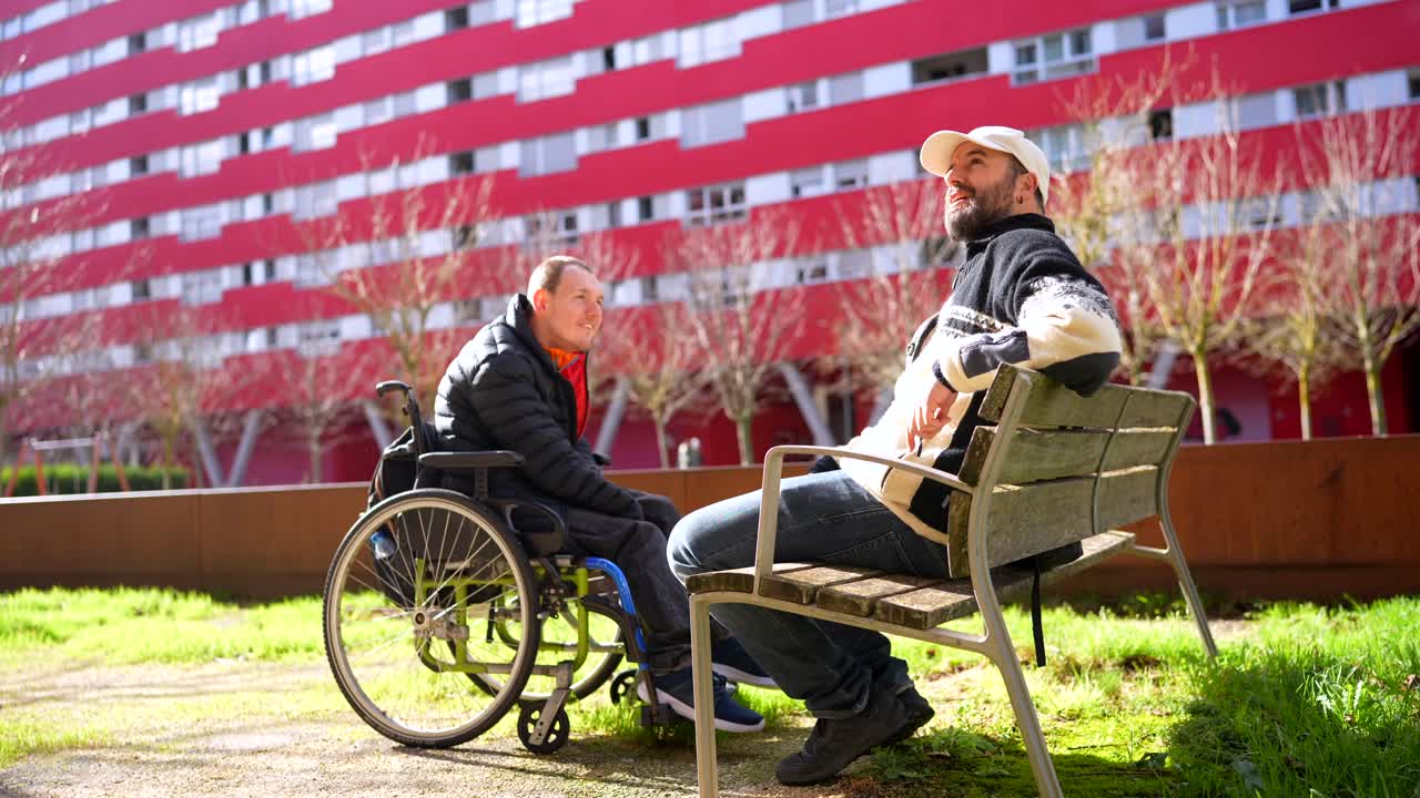 People in a park, one in a wheelchair