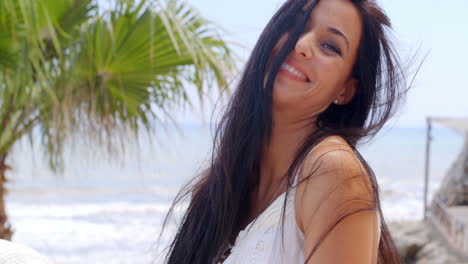 Cheerful-Woman-at-the-Beach-Looking-at-the-Camera