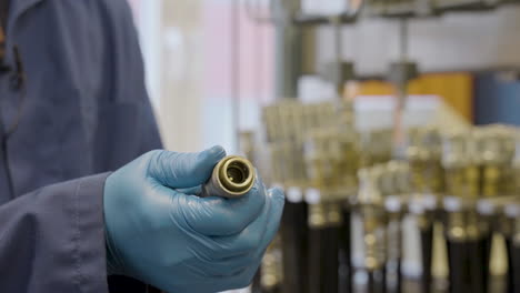 Engineer-with-gloves-checking-pressure-of-hose-in-industrial-Hydraulic-Laboratory,close-up-shot