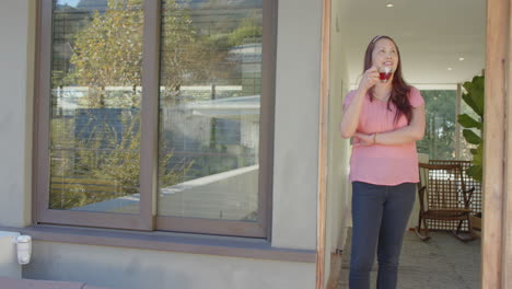 standing outside, woman enjoying ice cream and looking into distance