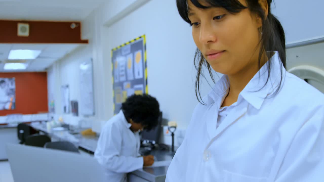 Premium stock video - Laboratory technician using laptop in blood bank 4k