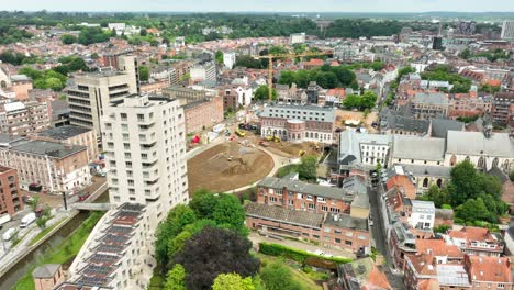 aerial orbit hertogensite construction site leuven with city reveal