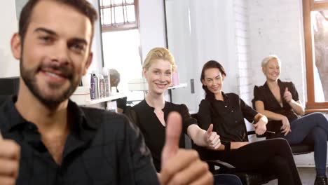 Portrait-of-smiling-hairstylist-showing-thumbs-up