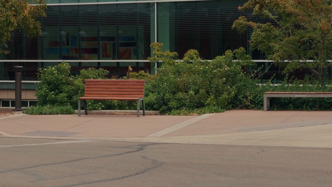 A left-to-right glide gradually hides benches and shrubs behind a blurred wall.