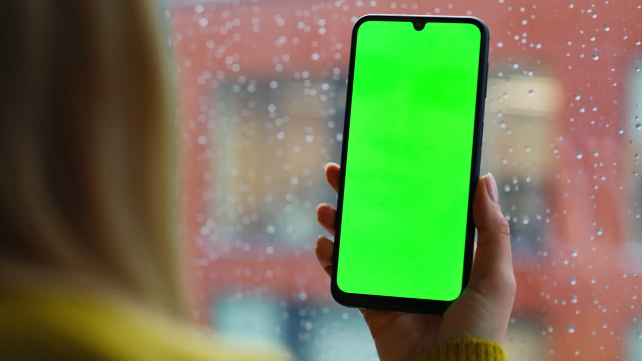 Girl fingers zooming mockup cellphone watching social media by window closeup