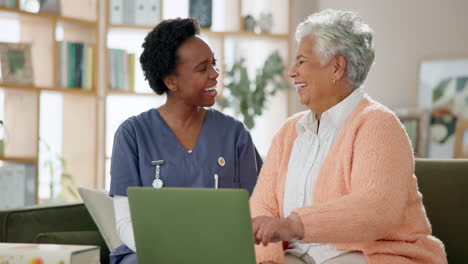 caregiver assisting elderly woman with a laptop