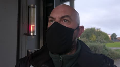 male opening car wash workplace wearing ppe corona virus face mask at stop sign dolly left