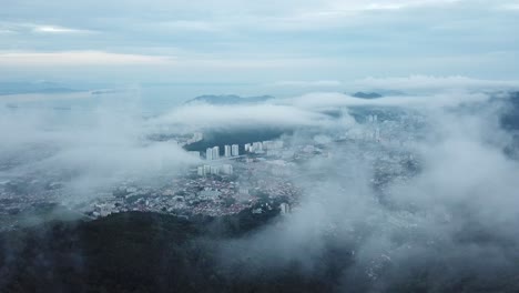 aerial fly over cloud toward ayer itam city, penang.