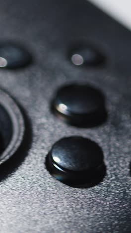 Vertical-Video-Close-Up-Of-Video-Game-Controller-Rotating-White-Background