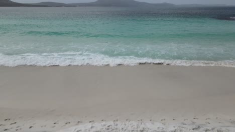 Drone-aerial-over-Little-Beach-with-blue-waters-on-cloudy-day