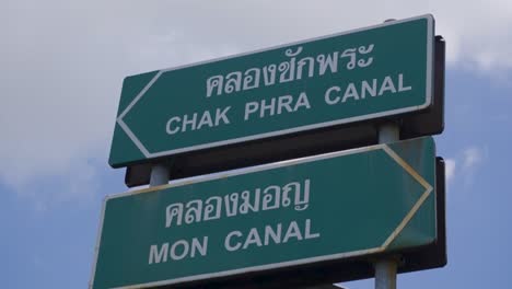 handheld shot of boat sign along chao phraya river in the day in bangkok, thailand