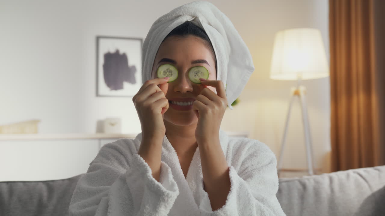 Woman enjoying a cucumber eye mask spa treatment at home