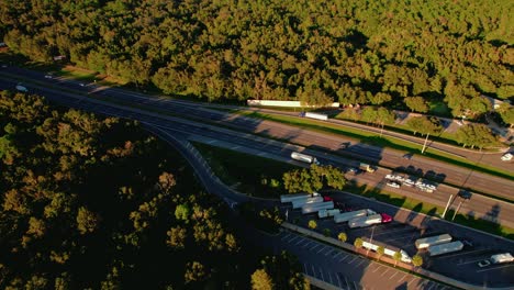 orbiting-aerial-following-a-semi-truck-exiting-rest-area-stop-after-10-hours-of-sleep