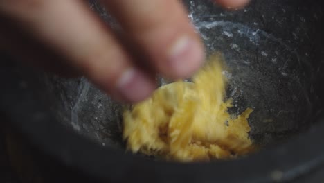 Adding-garlic,-brown-sugar-and-salt-ingredients-into-black-ceramic-bowl