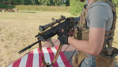 male hands assembling sniper rifle