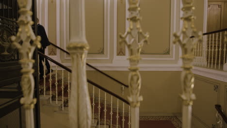 Elegant Couple Walking Upstairs in a Grand Hotel