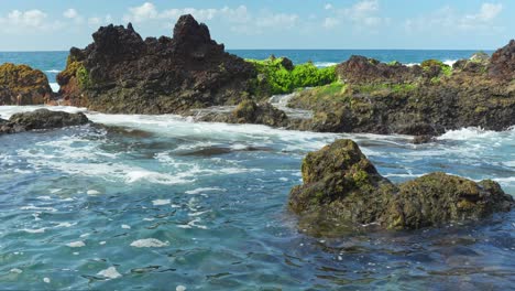 Waves-Crushing-Rocks-on-Sunny-Tourist-Location,-Relaxed-View-of-Holiday-Destination