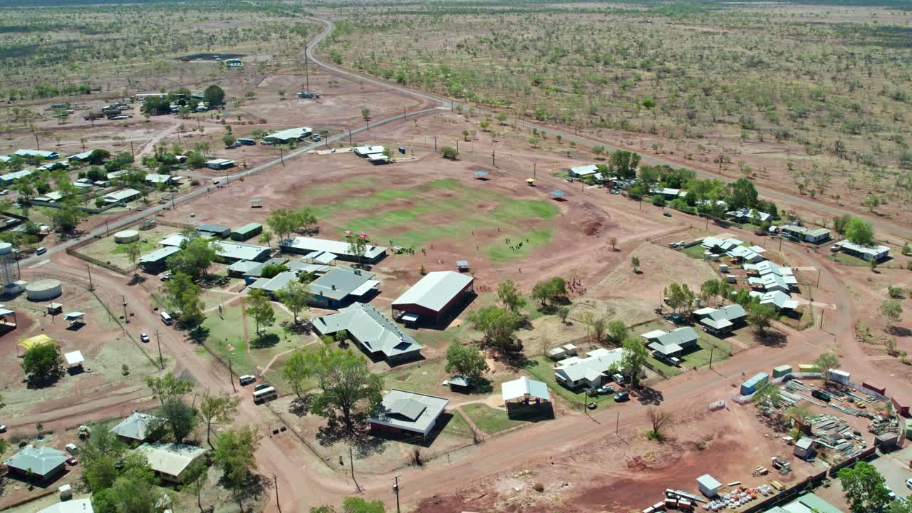 Reverse aerial footage over the Kalkarindji School in the communtiy of Kalkarindji, Gurindji, Northern Territory, Australia, August 2022.