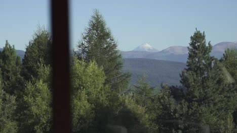 amazing window view of big snowy mountain and trees vegetation slow motion and 60 fps