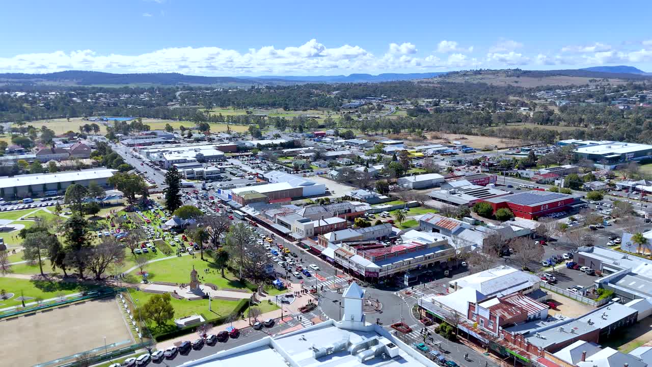 Community gathers outdoors for festival in sunny rural town