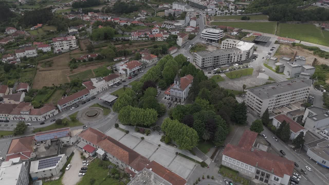 church and green square surrounded by buildings in Lousada village Portugal