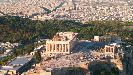 tight circling aerial shot of the athens parthenon with philopappos hill in the background