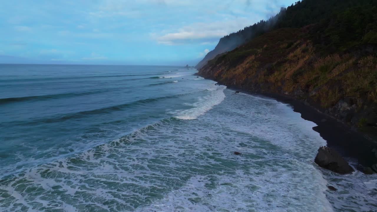 Surf waves PNW Lost Coast Trail rugged dramatic untouched coastline aerial drone California boulder rocks USAL Beach campground cloudy shaded mist fog sun rays morning nature landscape forward upwards