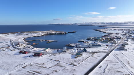 Aerial-drone-panning-view-of-Raufarhöfn-on-a-sunny-winter-day-covered-with-snow