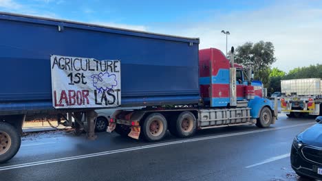 truck with 'agriculture 1st labor last' protest banner