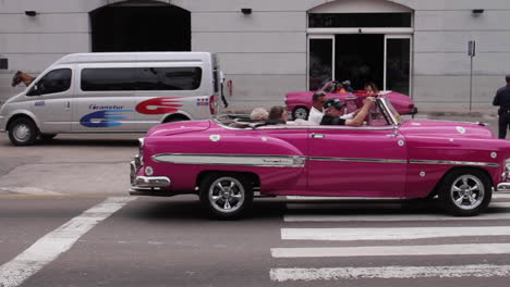 horse-drawn carriages and classic cars on city streets