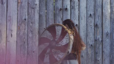 viking woman warrior runs from the gate to the castle