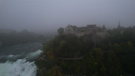 fog surrounding laufen castle and rhine falls in switzerland