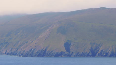 Ireland-Rugged-Cliffs-and-Countryside,-Telephoto-Shot---Zoom-Out