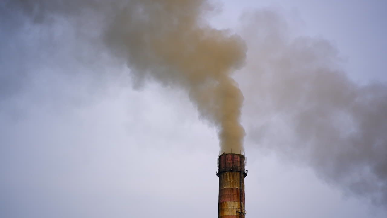 Tube emits harmful emissions. Industrial pipe polluting the environment. Pipe factory from which the chemical smoke comes.