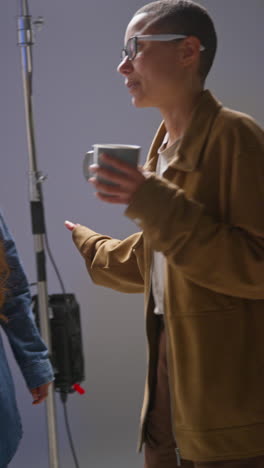 Vertical-Video-Of-Film-Director-Talking-With-Female-Actor-Shooting-Movie-In-Studio-Shot-In-Real-Time