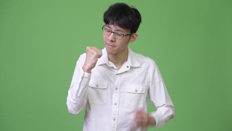 young asian businessman giving thumbs down