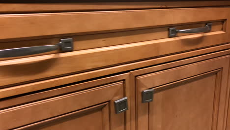 Kitchen-cabinet-door-and-drawers-in-slow-motion,-cabinets-are-made-of-natural-maple-wood-in-red-maple-colors-and-traditional-door-style