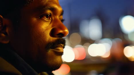 a man looking out into the city at night