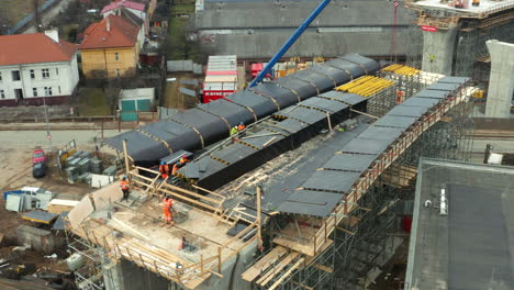 construction workers working on building of bridge in city urban area