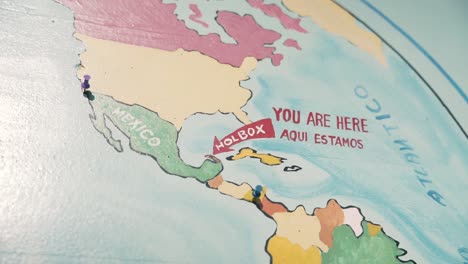 a map with red arrow pointing to holbox island in mexico