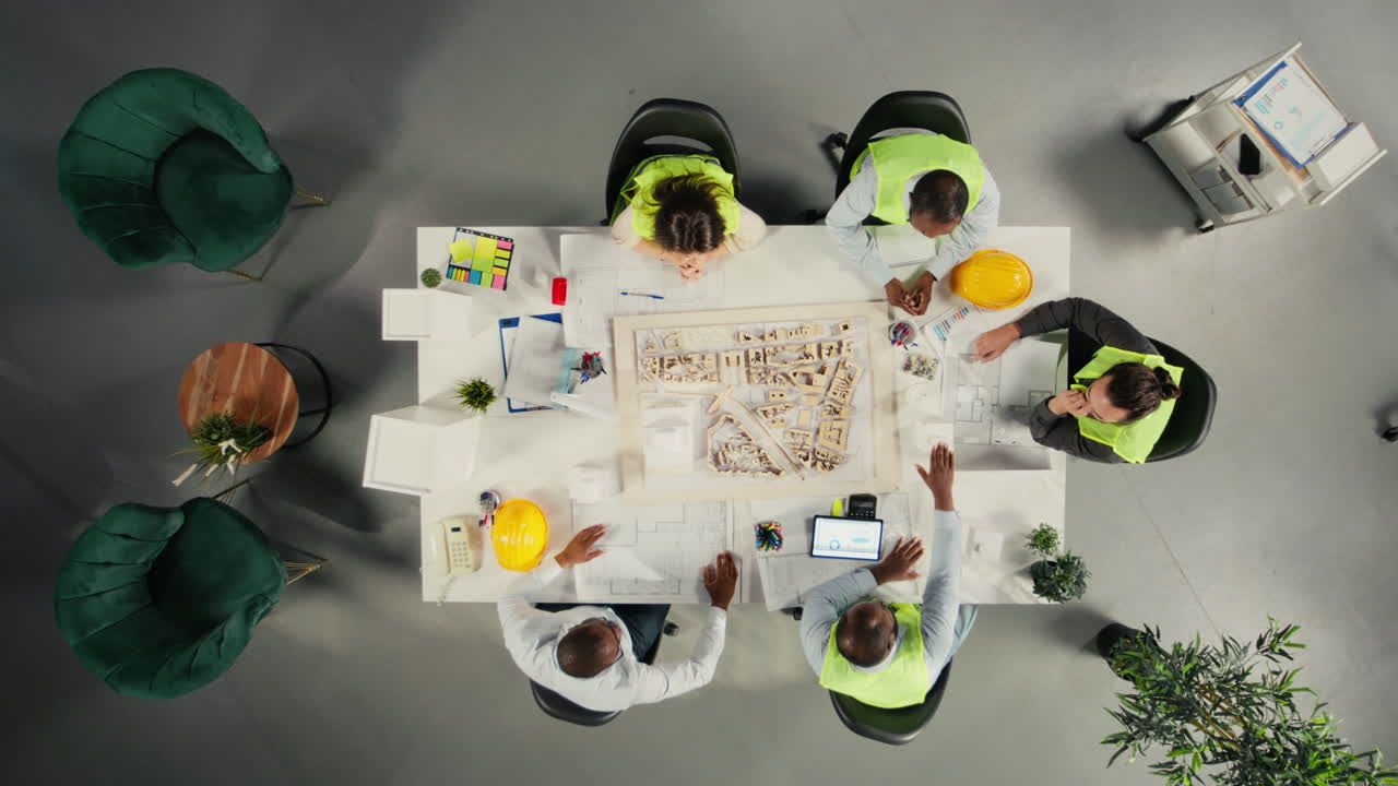 Vertical Video Top down view of development team consulting on real estate investment