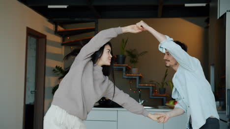 couple dancing in kitchen and living room
