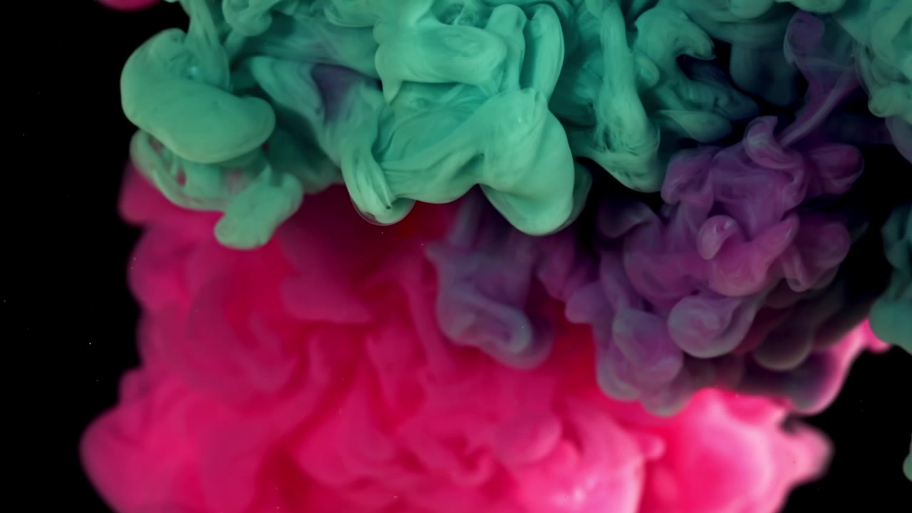 Farverige blækskyer hvirvler i slowmotion på sort baggrund